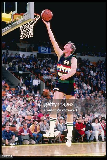 Dan Issel of the Denver Nuggets lays the ball up during the Nuggets match against the Los Angeles Lakers at the Great Western Forum in Inglewood,...