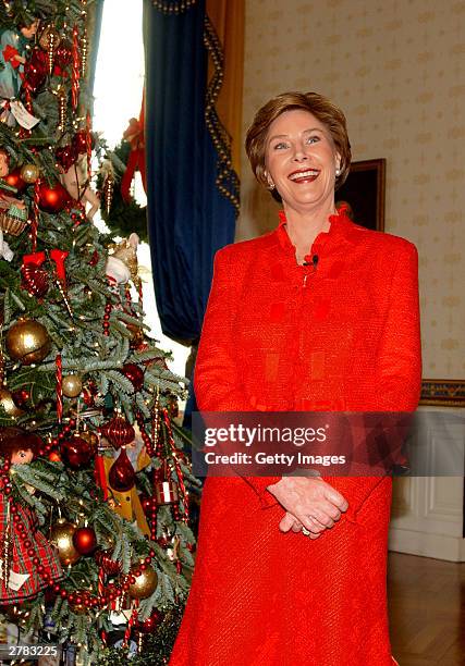 First lady Laura Bush smiles as she unveils the 2003 White House Christmas decorations in the State Dining Room of the White House December 4, 2003...