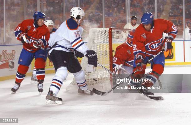 Left wing Brad Isbister of the Edmonton Oilers looks to score as Craig Rivet of the Montreal Canadiens plays defense during the game at the Molson...