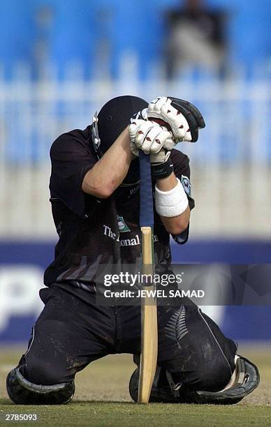 Dejected New Zealand batsman Brendon McCullum kneels after being dismissed during the fourth One Day International match between Pakistan and New...