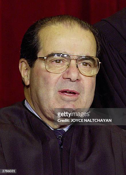 Associate Justice Antonin Scalia looks on as the the Supreme Court of the United States pose for an official photo, 05 December 2003 at the Supreme...