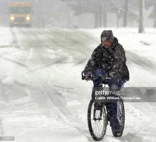 Andre C. Taylor, of Warminster, Pennsylvania rides his bicycle home from work during a winter storm December 5, 2003 in Warminster, Pennsylvania. The...