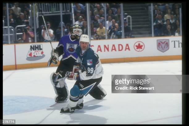 Center Wayne Gretzky of the New York Rangers covers goaltender Andy Moog of the Dallas Stars during the 47th NHL All-Star game at the San Jose Arena...