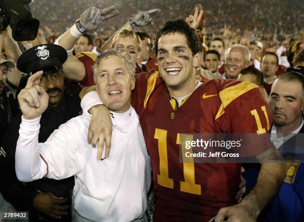 Head coach Pete Carroll and quarterback Matt Leinart celebrate following their 52-28 victory over Oregon State on December 6, 2003 at the Los Angeles...