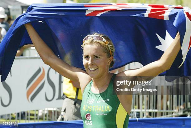 Emma Snowsill of Australia holds up the Australian flag after winning the Women's Elite event at the ITU World Triathlon Championships December 7,...