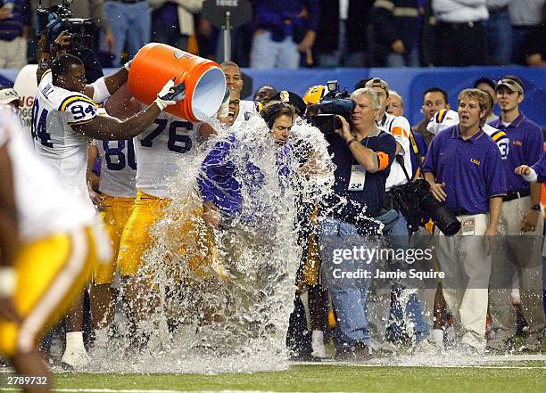 Head coach Nick Saban of LSU Tigers is drenched with water as the LSA Tigers defeated the Georgia Bulldogs to win the SEC Championship Game on...
