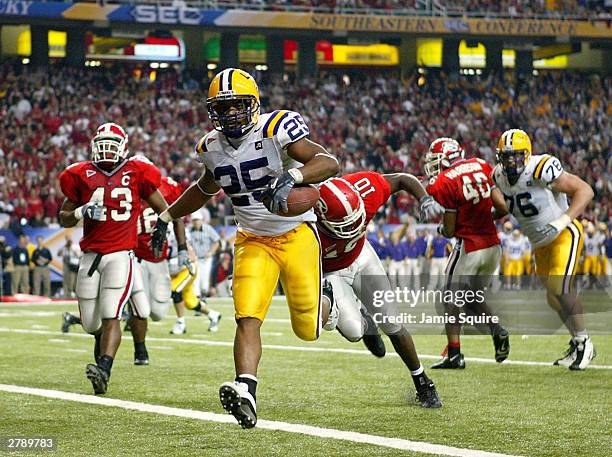 Justin Vincent of the LSU Tigers crosses the goalline to score a touchdown against the Georgia Bulldogs during the SEC Championship Game on December...