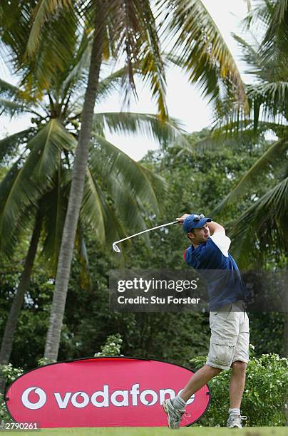 England bowler James Anderson tees off on the first during the Vodafone England Cricketers Golf day at the Victoria Golf club on December 7, 2003 in...