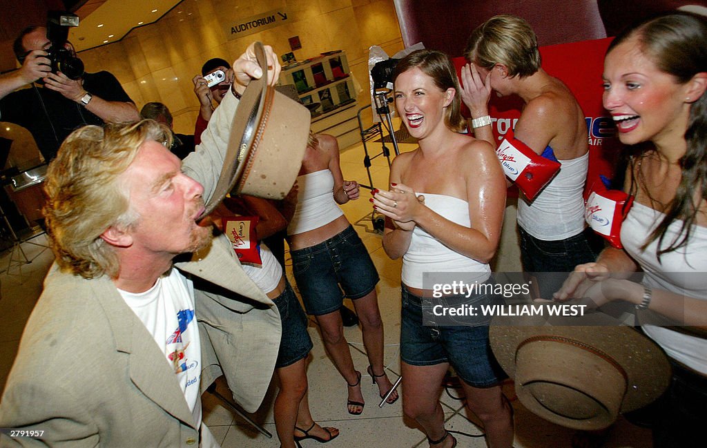 British tycoon Richard Branson (L) drink