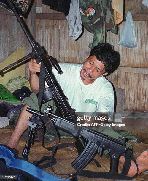 Photo dated 24 August 2003 shows Abu Sayyaf kidnap gang leader Galib Andang, popularly known as commander Robot, holding a machine gun in his hideout...