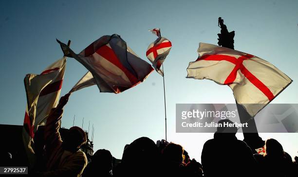 Fans wave flags in Trafalgar Square during the England Rugby World Cup team victory parade December 8, 2003 in London. Up to half a million...
