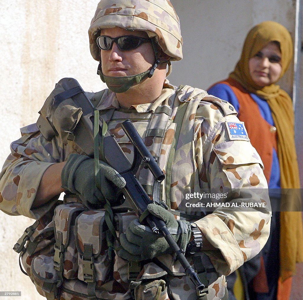 An Iraqi woman peers at an Australian so