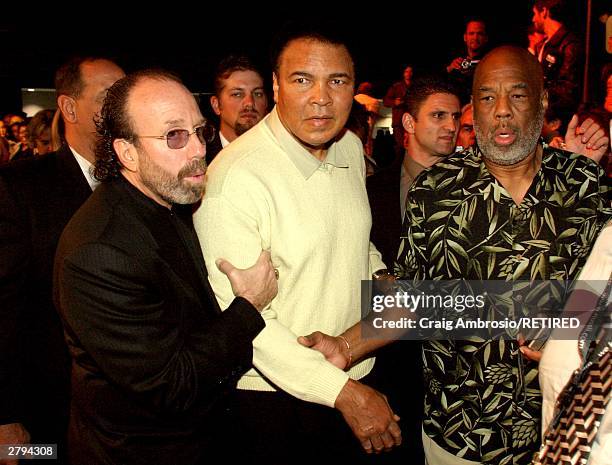 Manager Bernie Yuman escorts Boxer Muhammad Ali and Photographer Howard L. Bingham during Art Basel Taschen book premiere of Muhammad Ali's book,...