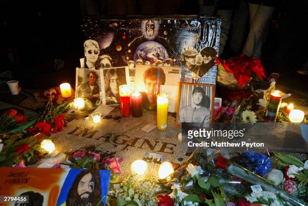 Fans mark the anniversary of musician John Lennon's death with a makeshift memorial at Strawberry Fields in Central Park December 8, 2003 in New York...