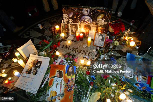 Fans mark the anniversary of musician John Lennon's death with a makeshift memorial at Strawberry Fields in Central Park December 8, 2003 in New York...
