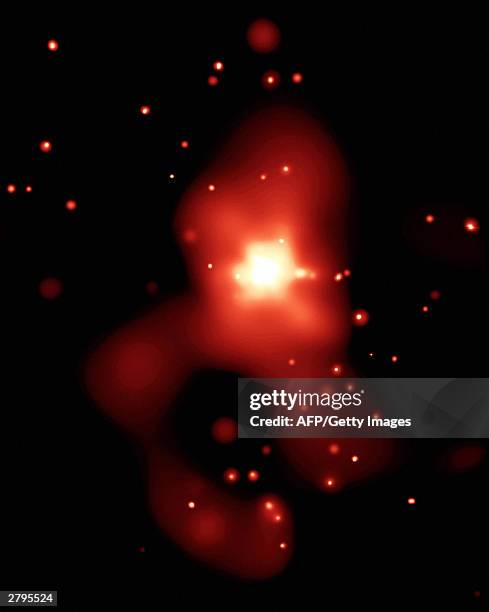 This NASA Chandra X-Ray Observatory image obtained 09 December, 2003 shows the elliptical galaxy NGC 4261 that reveals dozens of black holes and...
