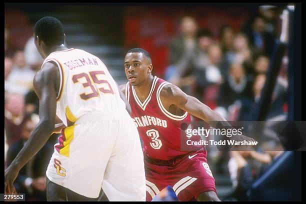 Guard Kris Weems of the Stanford Cardinal plays defense on USC Trojans guard Stais Boseman during a game at the Los Angeles Sports Arena in Los...