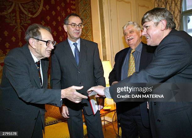French ambassador to Czech Republic Joel de Zorzi smiles 09 December 2003 at French embassy in Prague as he welcomes three former Czech dissidents,...
