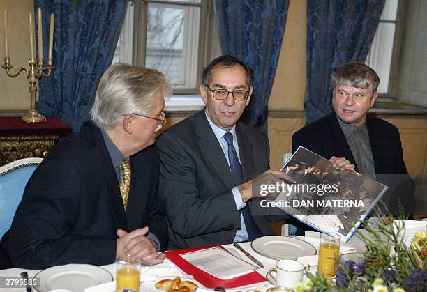French ambassador to Czech Republic Joel de Zorzi shows 09 December 2003 at French embassy in Prague to two former Czech dissidents, Jiri Dienstbier...