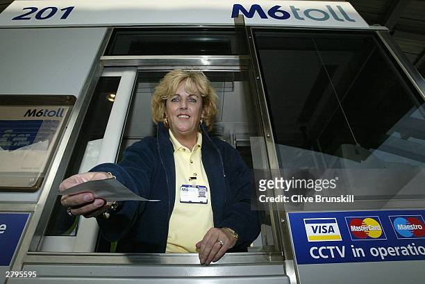 Toll booth assistant is seen at the new M6 motorway on December 9, 2003 in Birmingham, England. This marks the opening of the first phase of the dual...