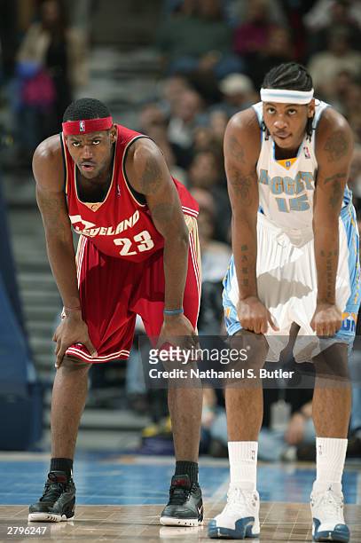 LeBron James of the Cleveland Cavaliers stands alongside Carmelo Anthony of the Denver Nuggets during the game at the Pepsi Center in Denver,...