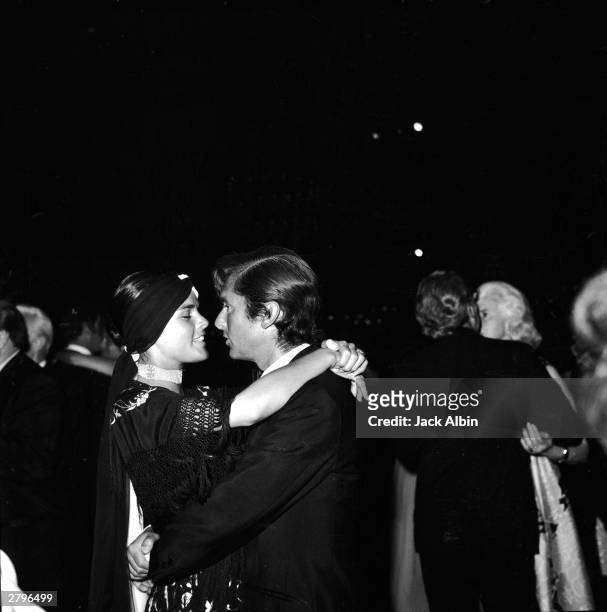 American actor Ali MacGraw dances with her husband, producer Robert Evans, at an Academy Award after party, Los Angeles, California, April 7, 1970.