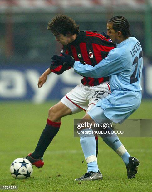 Milan striker Kaka of Brazil is tackled by Celta Vigo's Peter Luccin of France during their Champions League Group H soccer match at San Siro stadium...