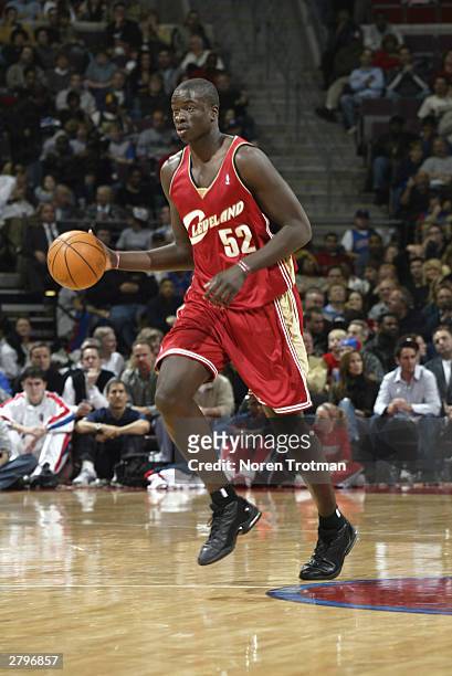 DeSagana Diop of the Cleveland Cavaliers drives against the Detroit Pistons during the game at The Palace of Auburn Hills on November 28, 2003 in...