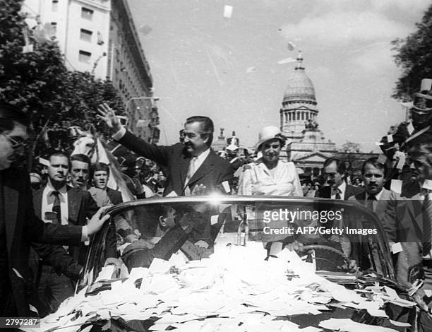 Argentine President elect Raul Alfonsin waves to the crowd 10 December, 1983 in Buenos Aires during his inauguration parade. Argentina will celebrate...
