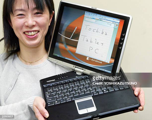 Japan's electronics giant Toshiba employee Junko Furuta displays the new tablet PC "dynabook SS M200", equipped with 1.4GHz Intel's Pentium M...
