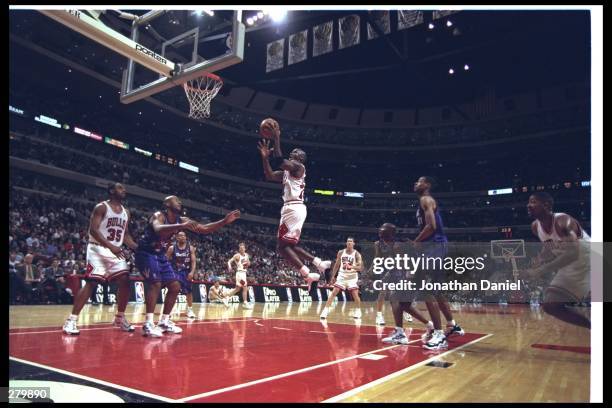Michael Jordan of the Chicago Bulls shoots from the air during their 117-100 win over the Toronto Raptors at United Center in Chicago, Illinois....