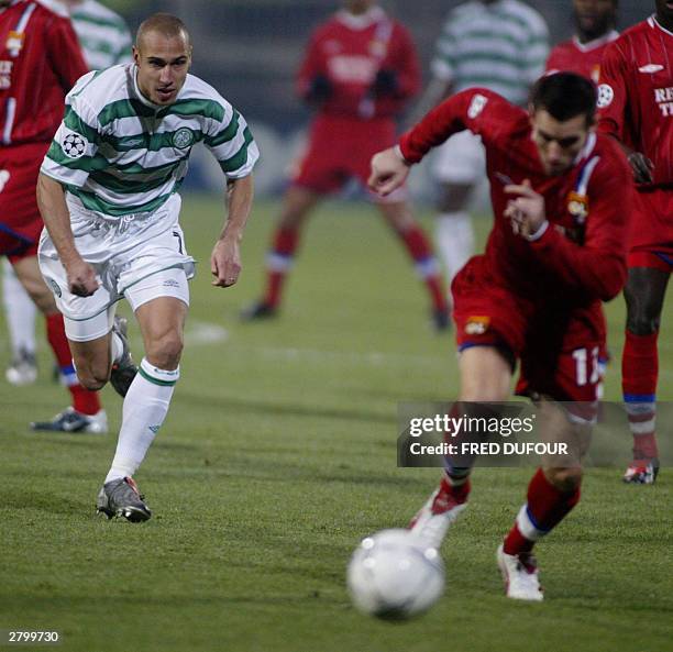 Celtic FC forwarder Henrik Larsson fights for the ball with Olympique Lyonnais defender Eric Carriere during the group A Champions League soccer...