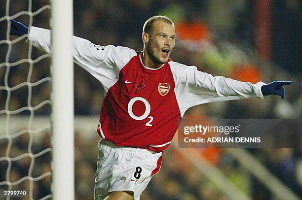 Arsenal's Fredrik Ljungberg celebrates scoring a goal against Lokomotiv Moskva during their Group B Champions League match 10 December, 2003 at...