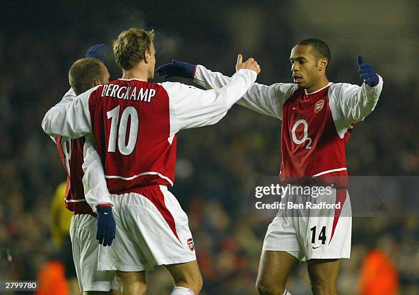 Thierry Henry of Arsenal celebrates with Dennis Bergkamp and Fredrik Ljungberg after Fredrik Ljungberg scored the second goal for Arsenal during the...