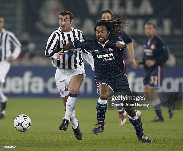 Christian Karembeu of Olympiakos beats Paolo Montero of Juventus during the UEFA Champions Group D match between Juventus and Olympiakos at Delle...