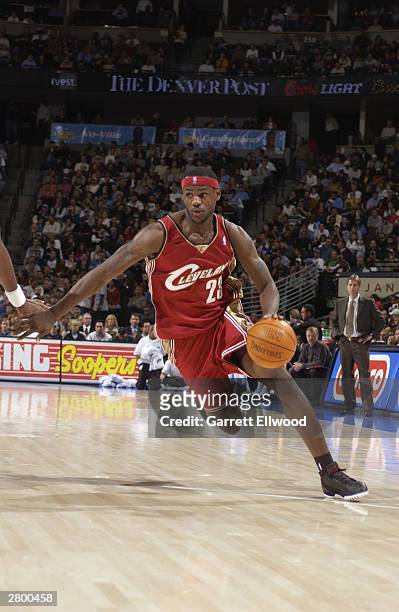 LeBron James of the Cleveland Cavaliers drives to the hoop during the game against the Denver Nuggets at the Pepsi Center on December 2, 2003 in...
