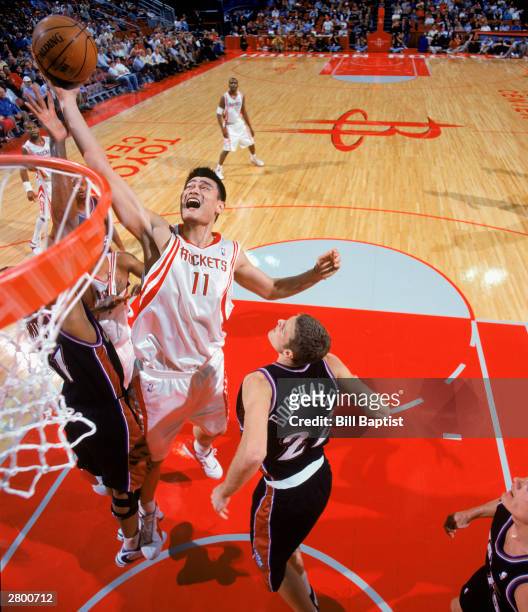 Yao Ming of the Houston Rockets takes the ball up against the Utah Jazz during the NBA game at Toyota Center on December 3, 2003 Houston, Texas. The...