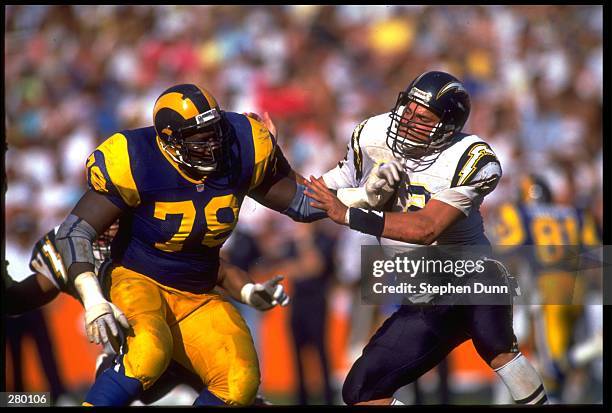 LOS ANGELES RAMS OFFENSIVE LINEMAN JACKIE SLATER BATTLES WITH SAN DIEGO CHARGERS DEFENSIVE LINEMAN BURT GROSSMAN DURING THE RAMS 30-24 WIN AT ANAHEIM...