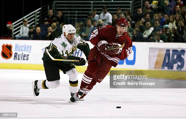 Bryan Savage of the Phoenix Coyotes skates for the puck against Stu Barnes of the Dallas Stars December 10, 2003 at America West Arena in Phoenix,...