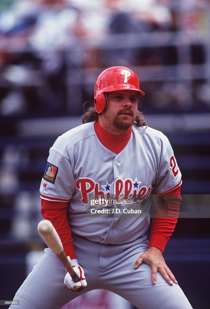 JOHN KRUK OF THE PHILADELPHIA PHILLIES CHECKS THE SIGNALS FROM HIS
