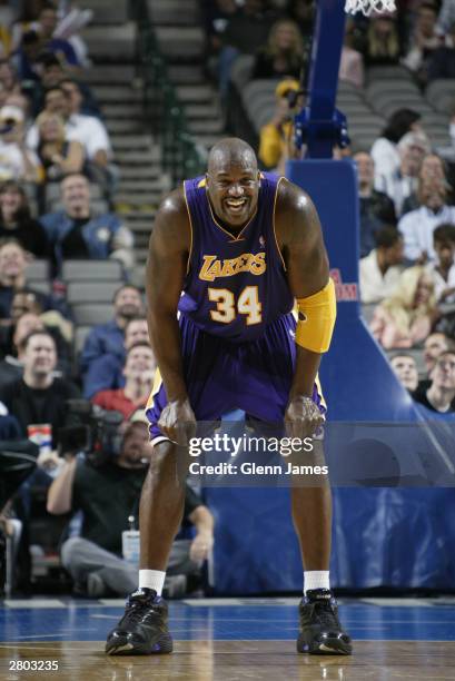 Shaquille O'Neal of the Los Angeles Lakers leans over on the court during the game against the Dallas Mavericks at the American Airlines Center on...