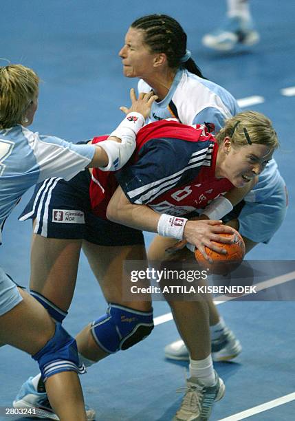 Norwegian Elsabeth Soerlie-Lybekk scores against Slovenian opponenets Katia Kurent and Ania Freser in a Women's World Championships match in Rijeka...