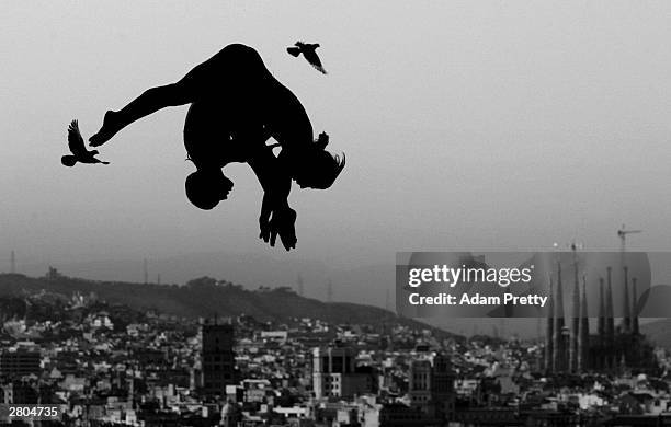 Dolores Saez de Ibarra Leire Santos of Spain Synchronised divers fly with the pigeons during training before the start of the 2003 World Swimming...