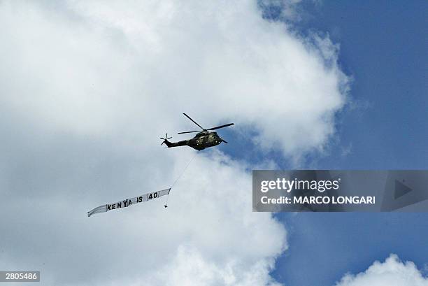 Puma chopper of the Kenyan Air Force flies a banner reading "Kenya is 40" over Nyaly Stadium in Nairobi, Kenya, where president Kibaki is attending...