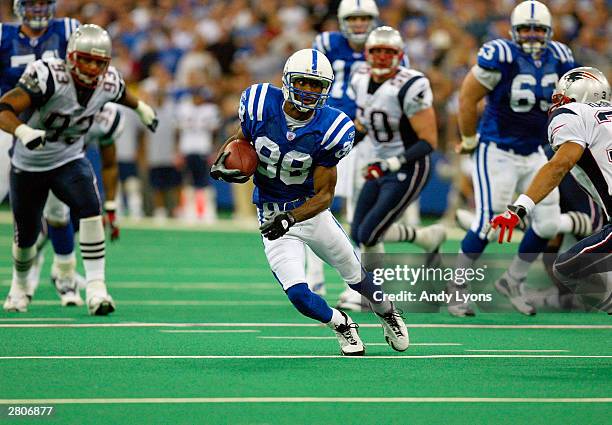 Wide receiver Marvin Harrison of the Indianapolis Colts carries the ball against the New England Patriots during the game at the RCA Dome on November...