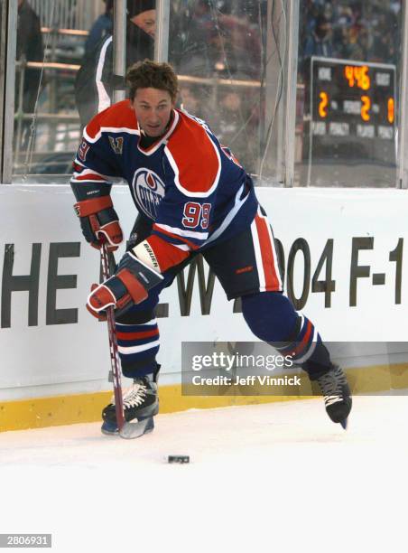 Wayne Gretzky of the Edmonton Oilers looks to make a play from behind the net against the Montreal Canadiens during the Molson Canadien Heritage...