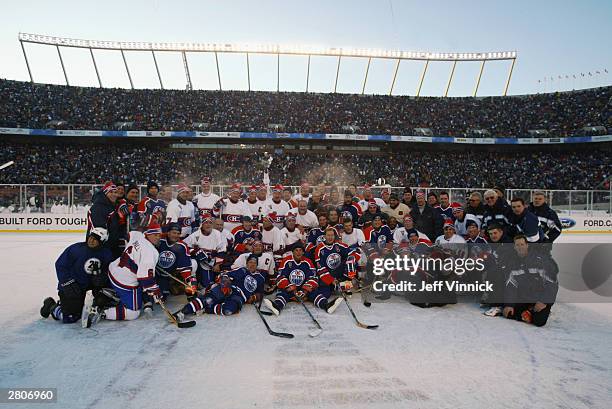 Members of the Montreal Canadiens and the Edmonton Oilers gather for a group photo after the Molson Canadien Heritage Classic Megastars Game on...