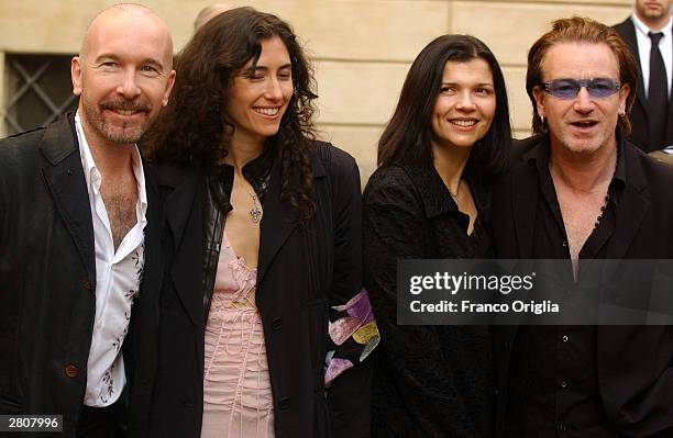 S quitarist The Edge and Irish Singer Bono with his wife Alison Stewart pose as they leave the Teatro Comunale at the end of the wedding of Luciano...