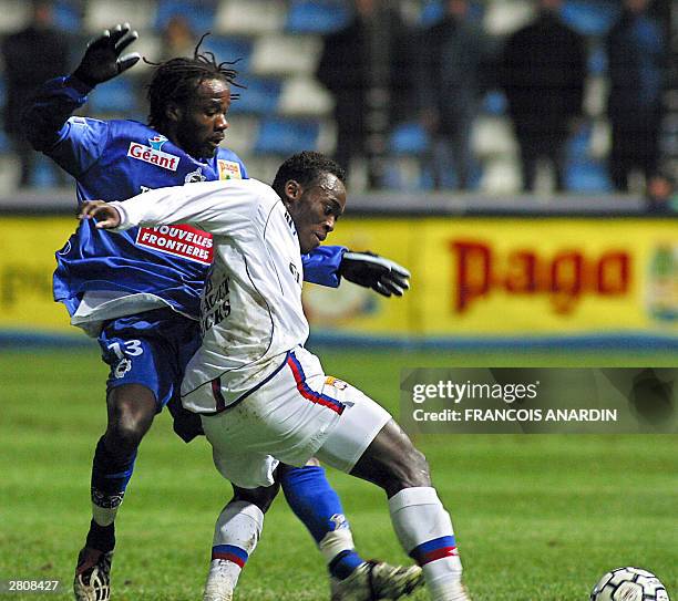 Bastia's defender Pascal Chimbonda vies with Lyon's midfielder Mickael Essien during their French L1 soccer match at the stadium Armand Cesari in...