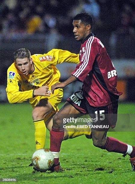 Guingamp's midifielder Kemal Bourhani fights for the ball with Nantes' defender Sylvain Armand during their French first League soccer match at the...